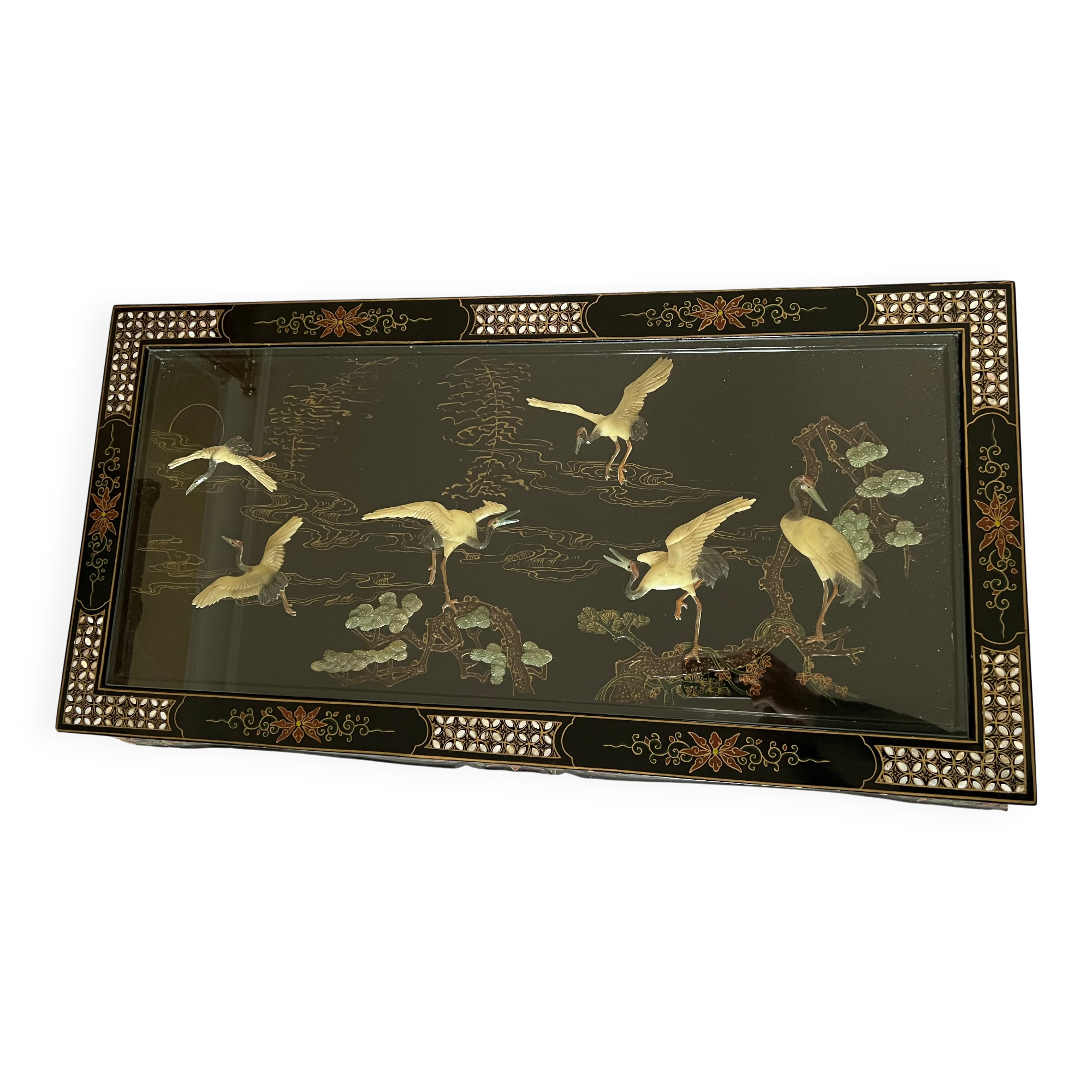 Chinese black wood table inlaid with mother-of-pearl featuring a relief scene of a crane.