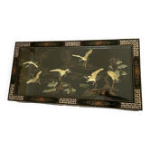 Chinese black wood table inlaid with mother-of-pearl featuring a relief scene of a crane.