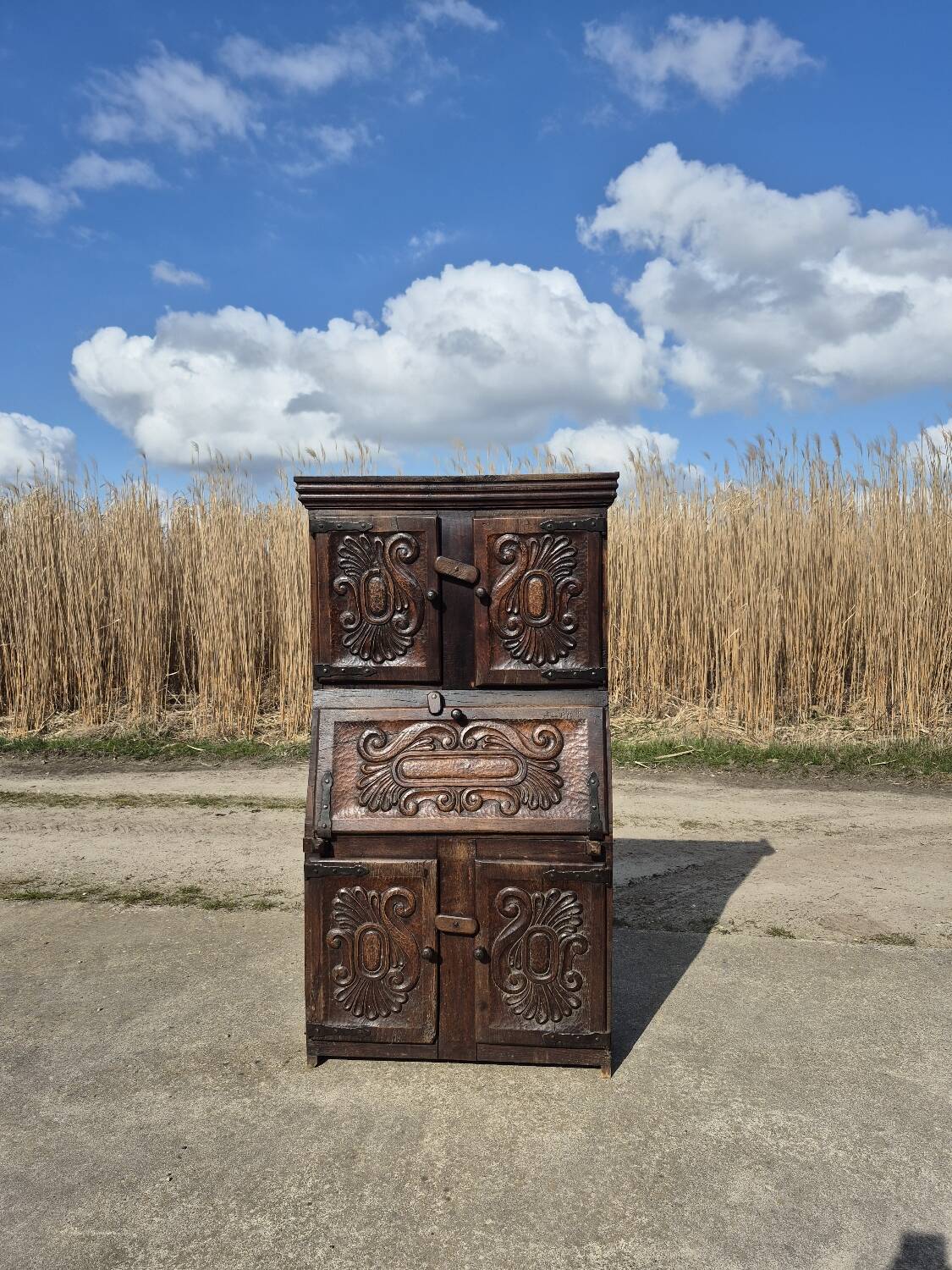 antique cabinet with carvings and wrought iron fittings rural