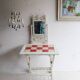 Antique white lacquered metal chandelier with wooden pendants.