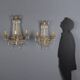 Antique wall sconces in gilded bronze with neoclassical motifs, 20th century.