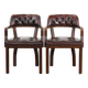 Set of two brown leather Chesterfield dining chairs in English style.