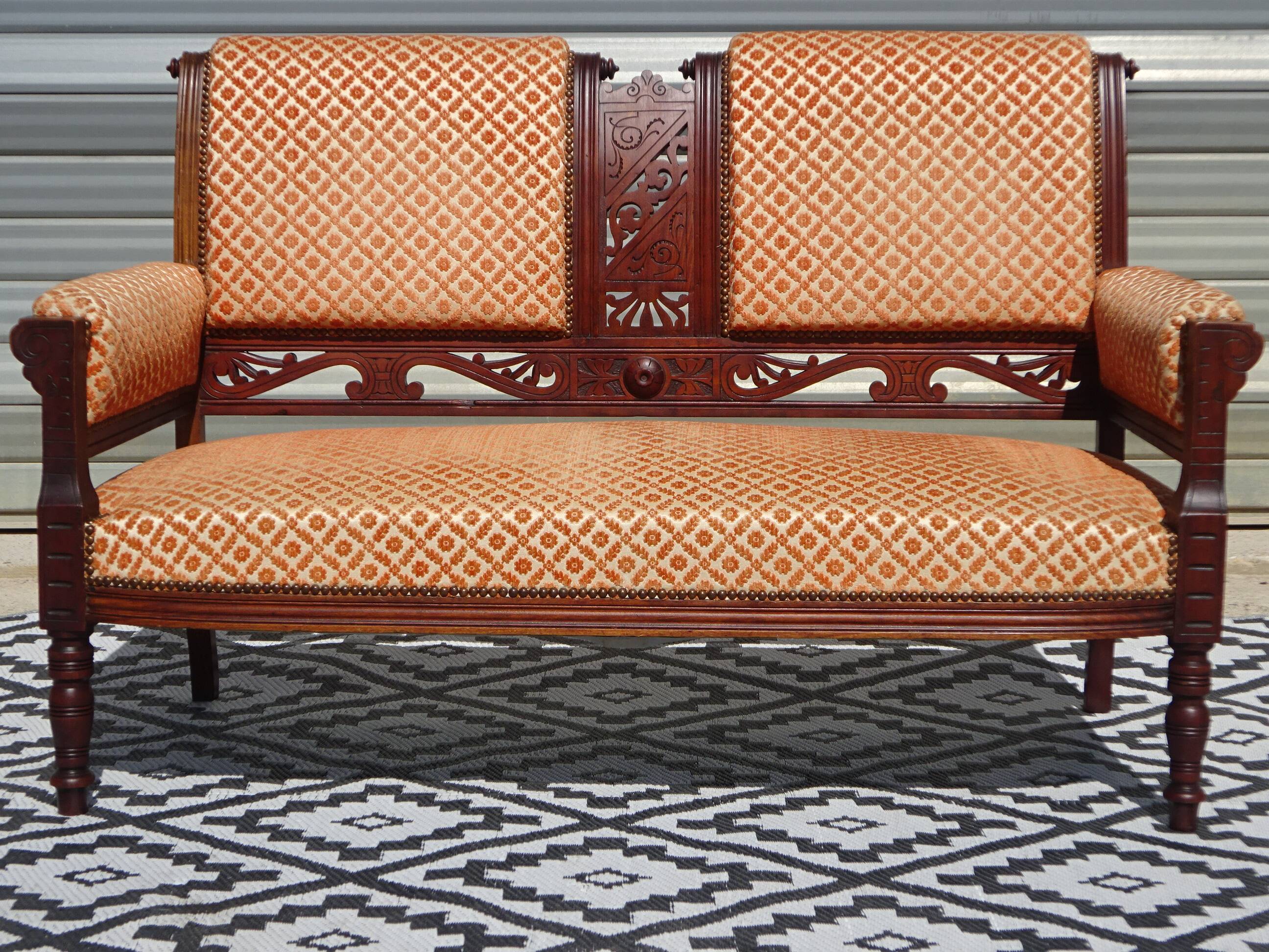 Vintage bench in wood and orange/ivory velvet.