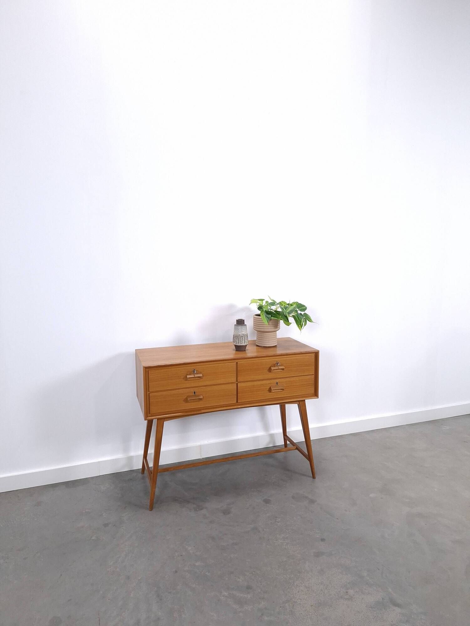 Vintage teak Danish chest of drawers with high slanted legs, side table, sideboard.