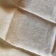 12 damask linen table napkins with an antique silk monogram from the 19th century.