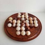 Solitaire game with stone balls