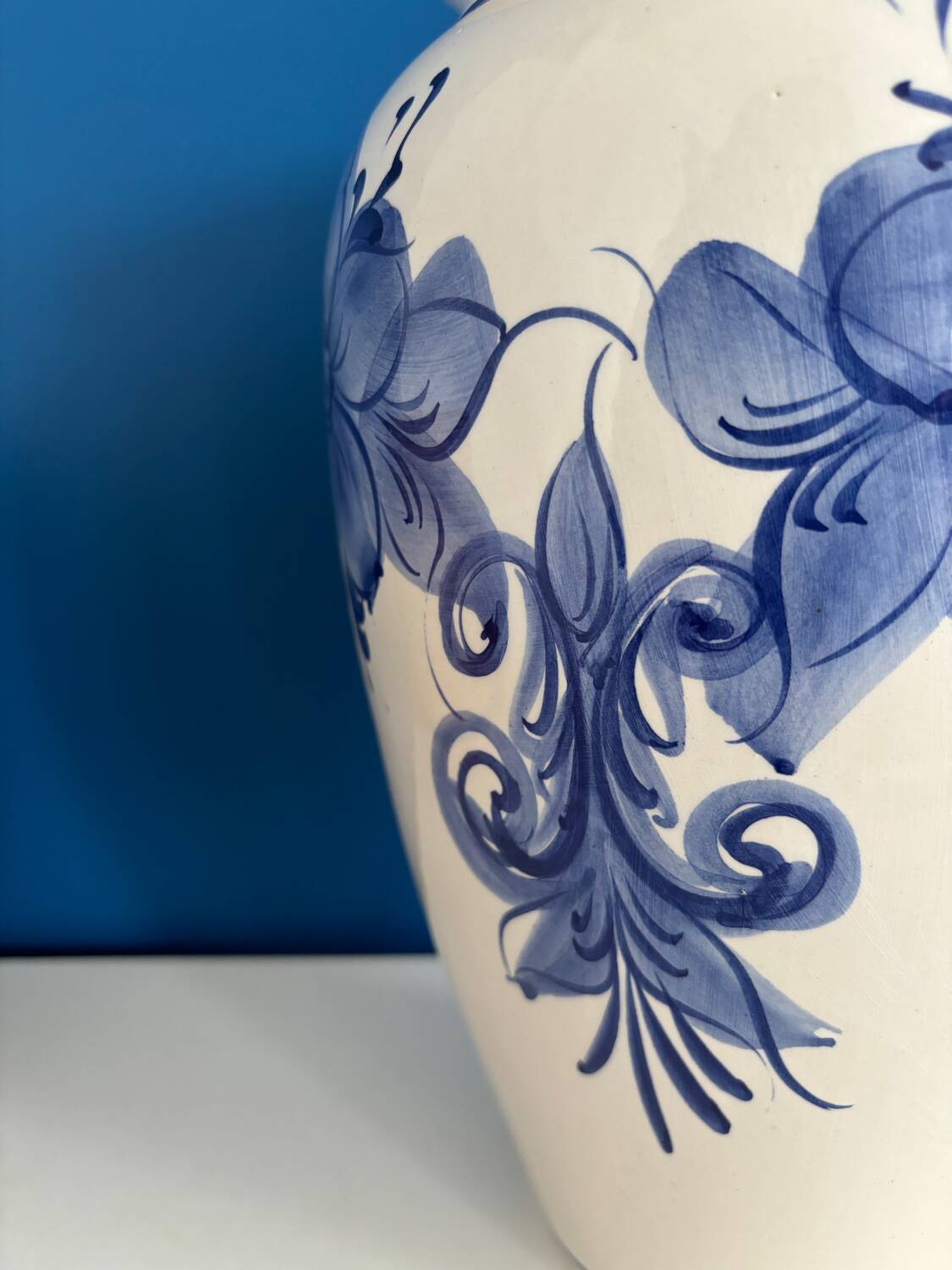 Vintage white and blue ceramic vase with floral pattern