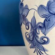 Vintage white and blue ceramic vase with floral pattern