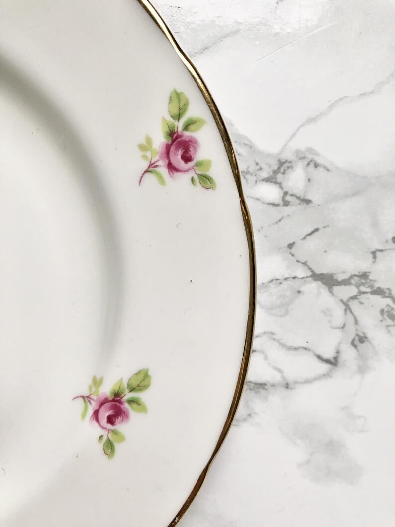 Teacup on its saucer and porcelain cake plate