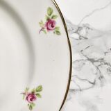 Teacup on its saucer and porcelain cake plate