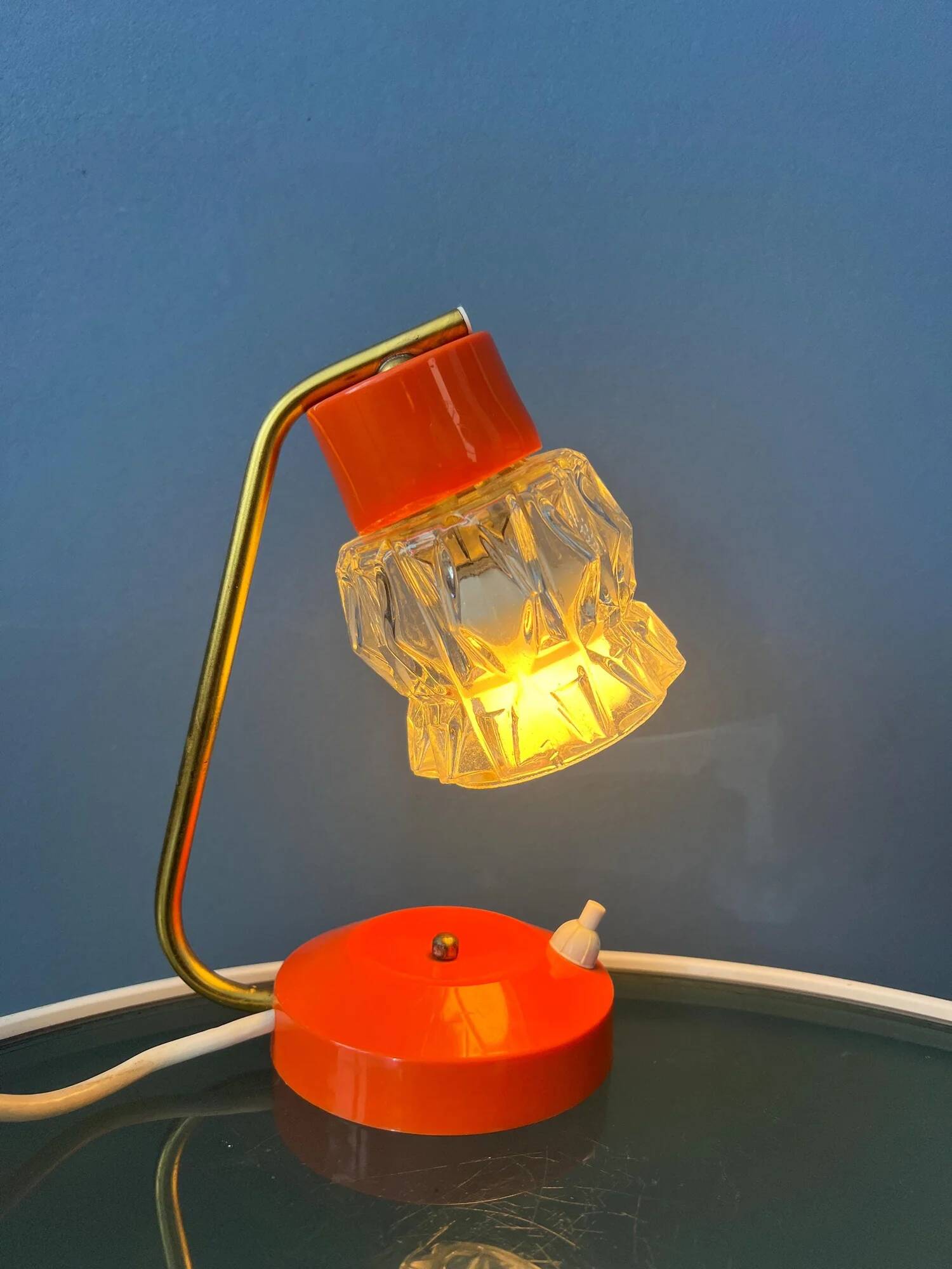 Small orange desk lamp with clear crystal glass shade