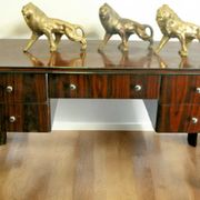A large Art Deco style rosewood desk with 5 drawers and decorative motifs