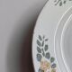 Old round footed plate signed Labrut brothers flowers