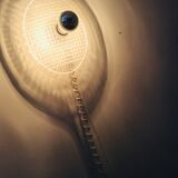 Apply tennis racket in 1980s Plexiglas