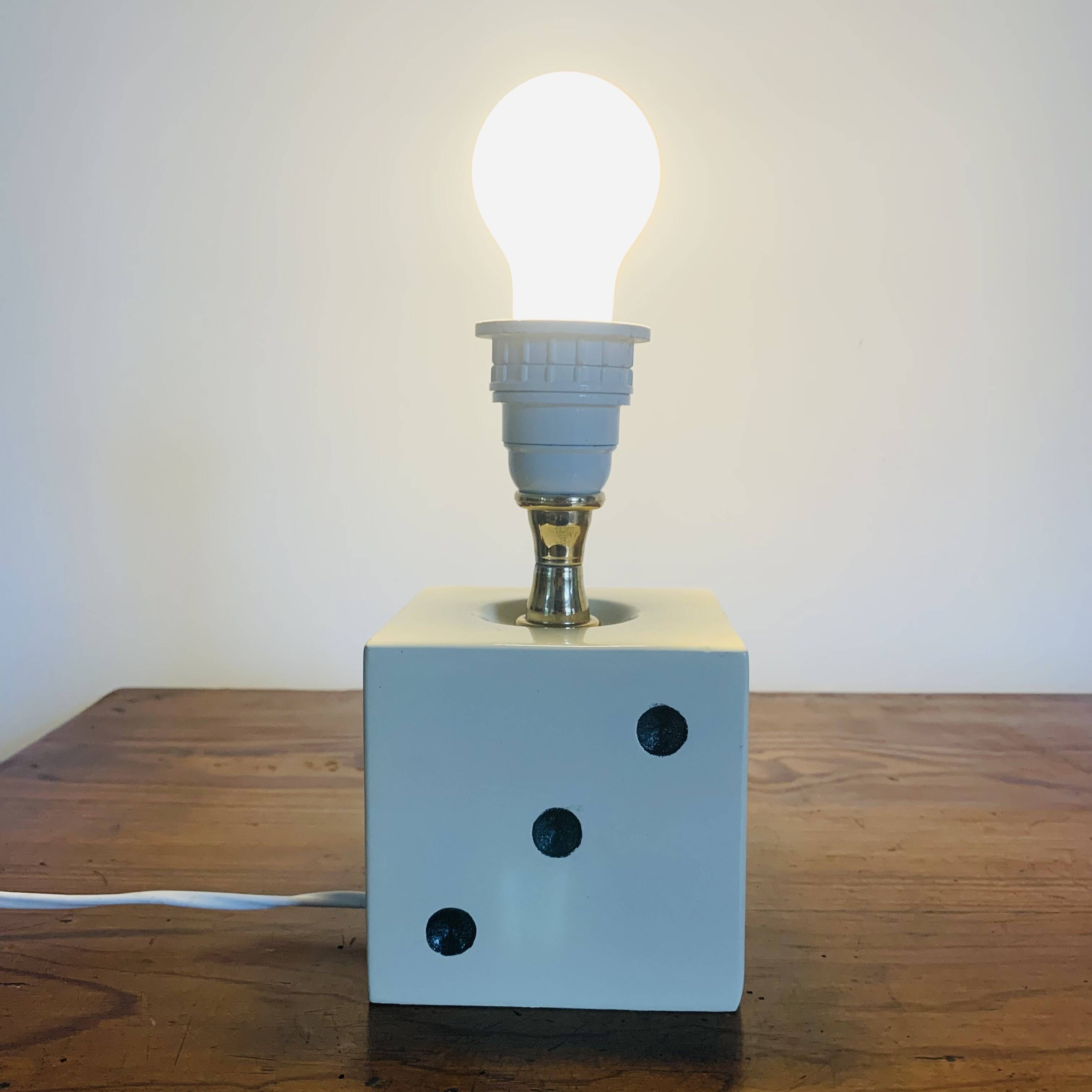 Lamp base representing a die