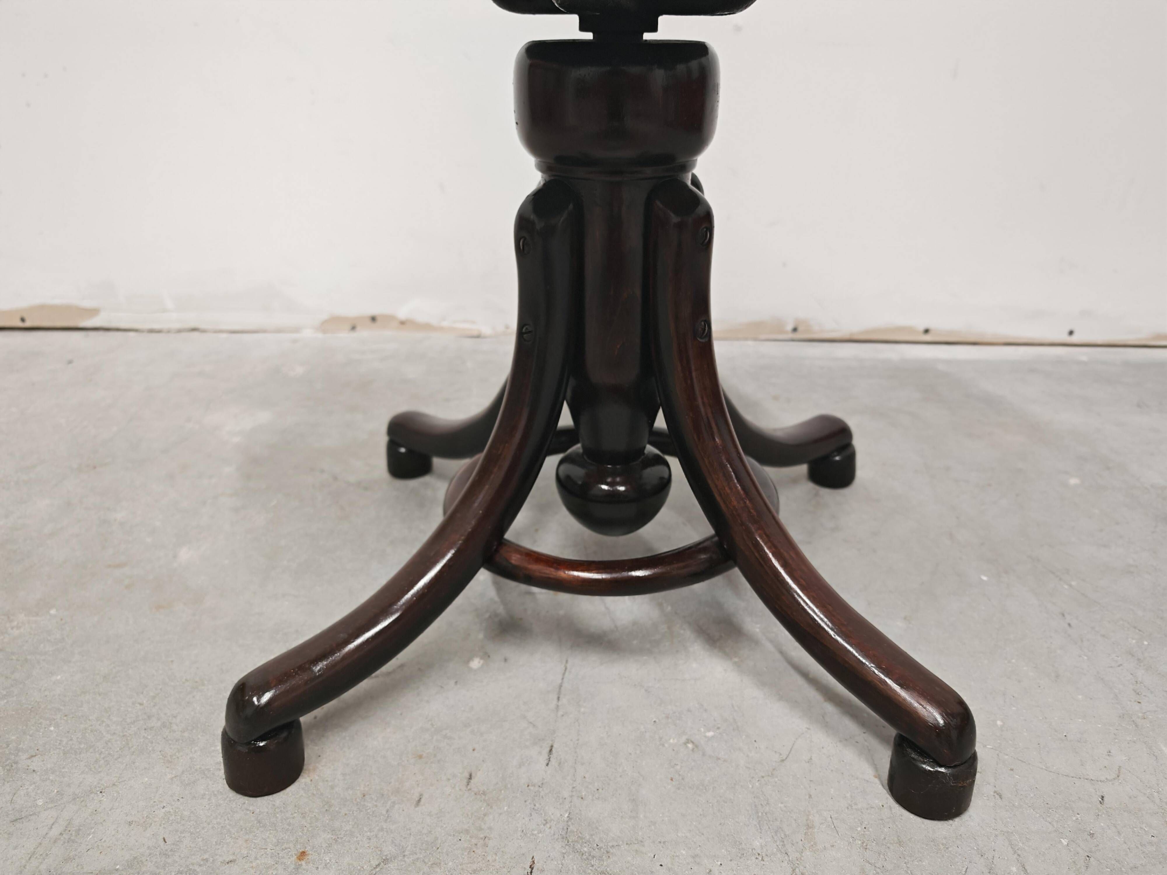 Antique curved wooden piano stool with kilim fabric from the 1910s.