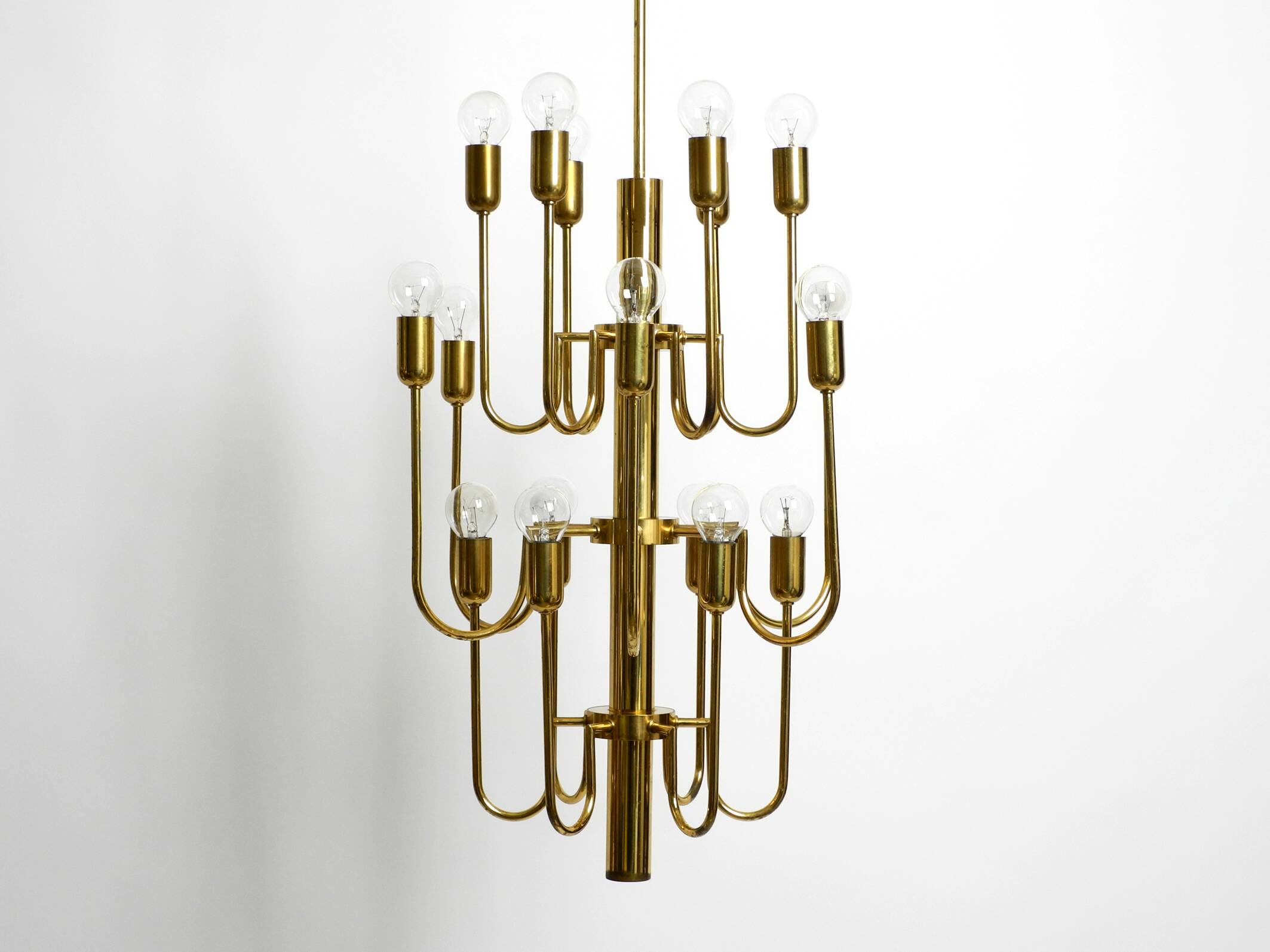 Three staged 18 arm Mid Century brass chandelier with a long brass rod