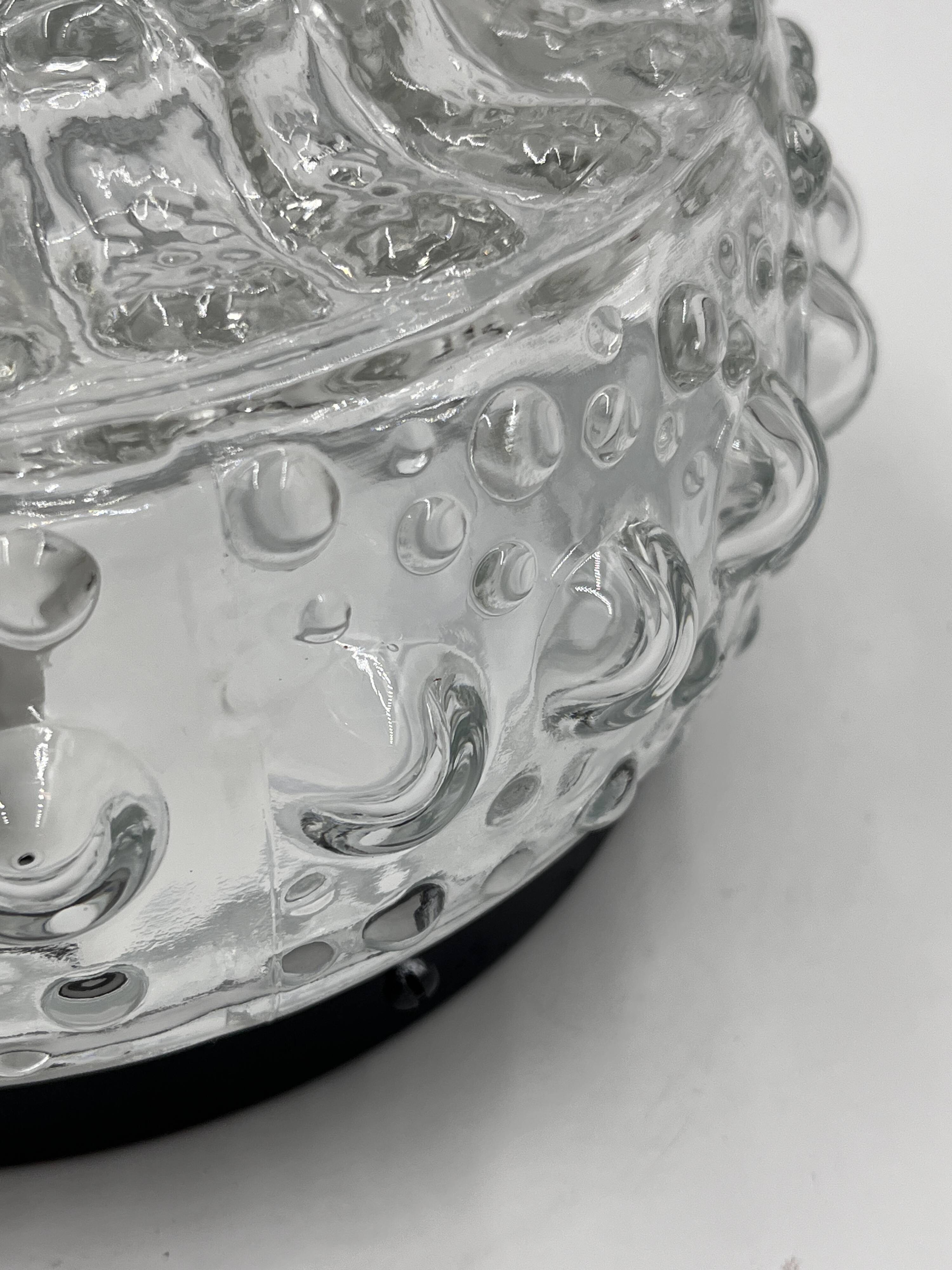 Molded glass ceiling light with spinning top relief