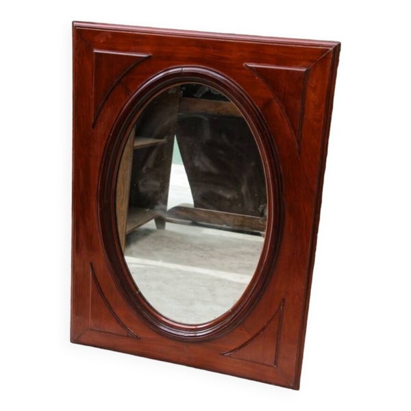 Miroir ovale en verre biseauté et acajou massif
