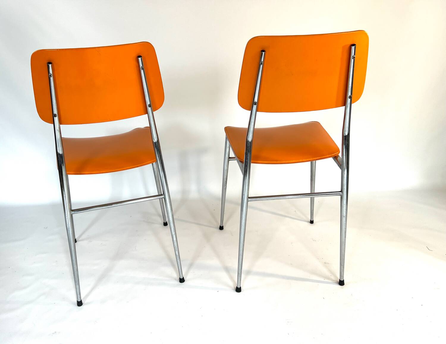 Pair of vintage orange leatherette chairs