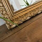 Antique mirror with a wooden and gilded stucco frame.