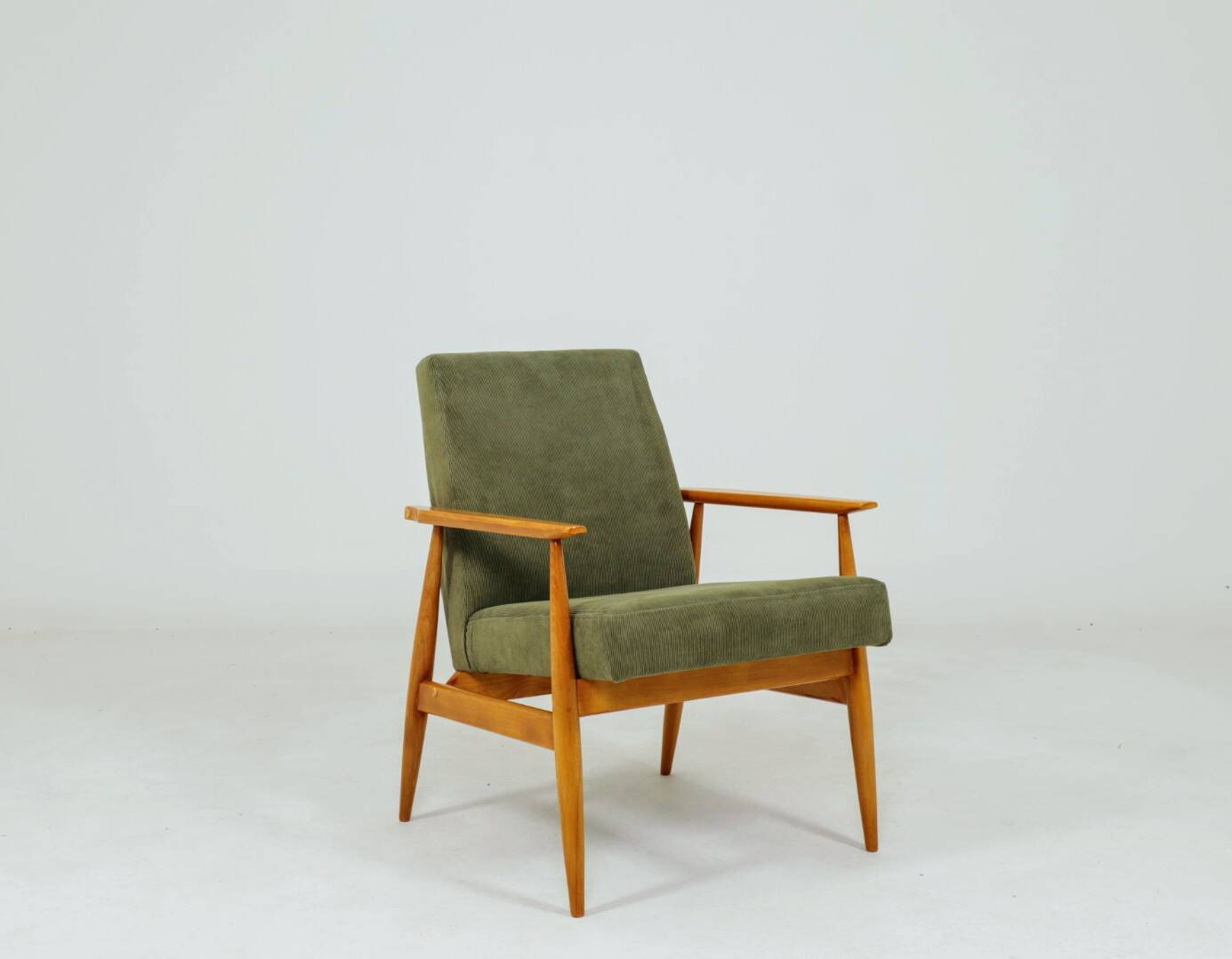 Mid-century modern design armchair in olive green corduroy.