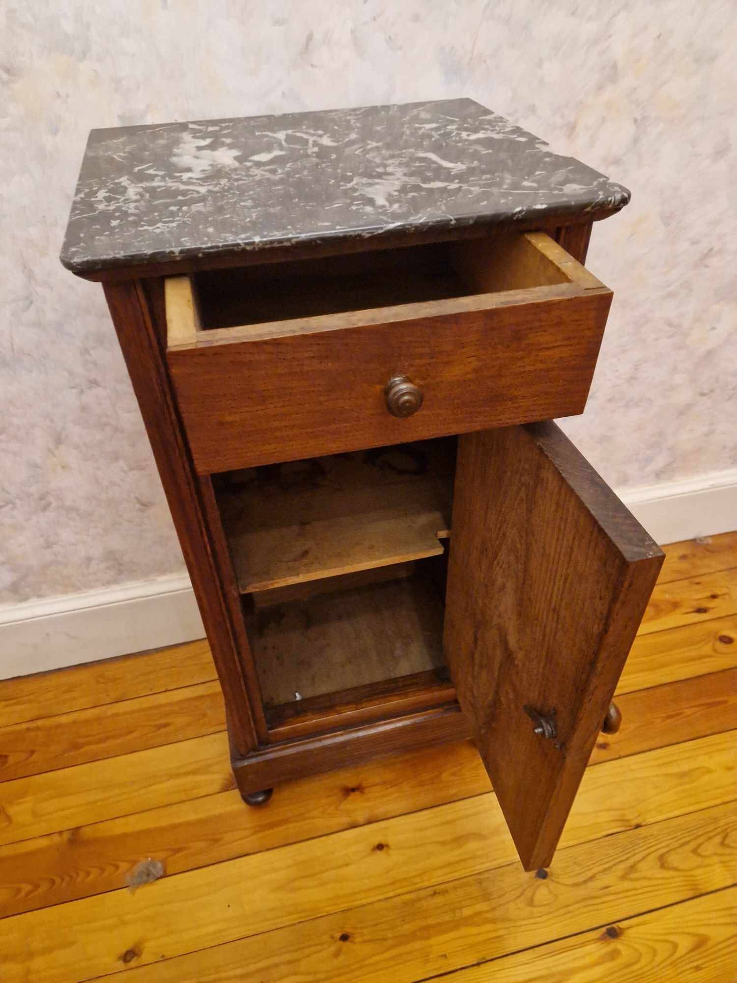 Antique wooden bedside table with black marble top