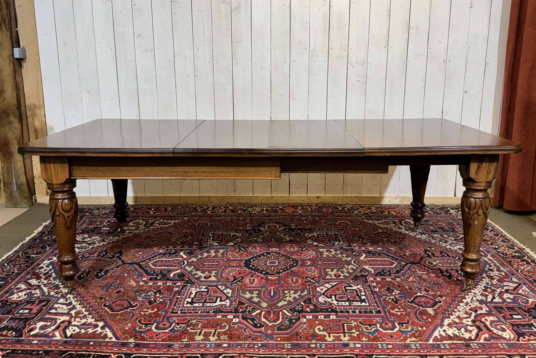 Victorian-style mahogany English table with 3 extensions.