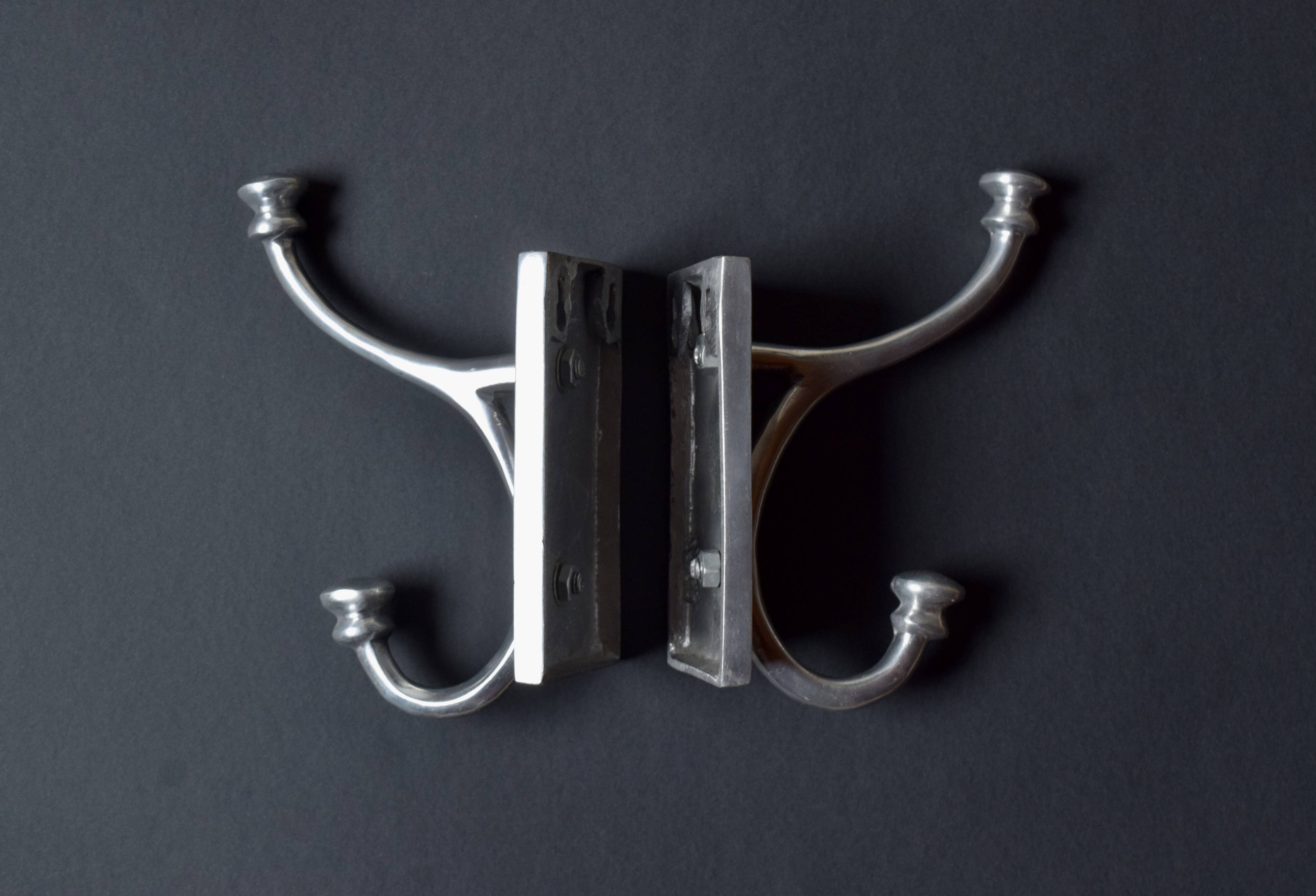 Pair of vintage cast aluminum coat hooks