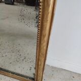 Long wooden mirror and gilded stucco with pearl rays H: 2m45 L: 40cm