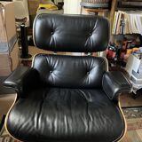 Black leather Eames Vitra armchair, original with rosewood ottoman.