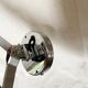 Vintage accordion wall light in chrome metal.