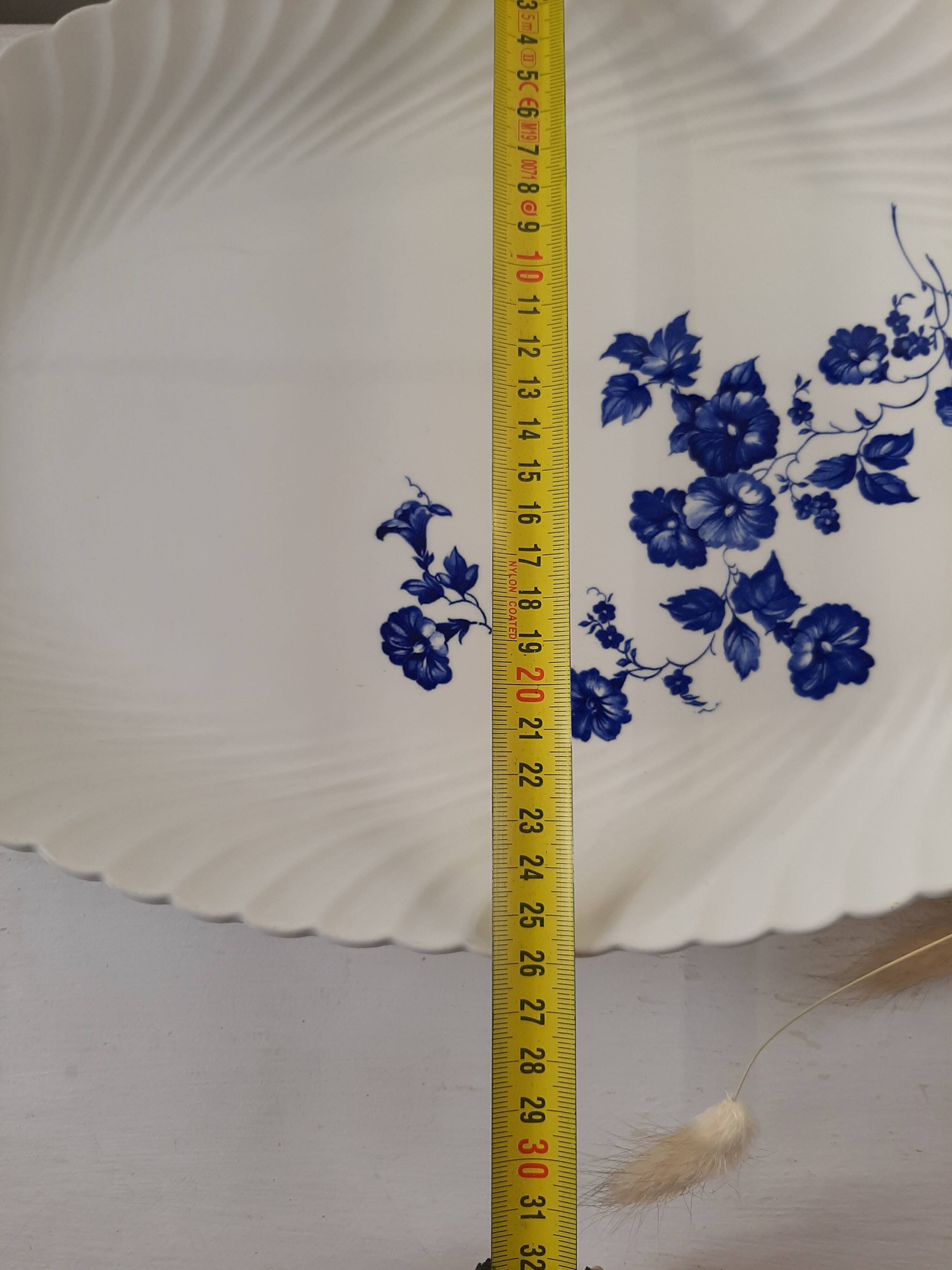 Keller and Guérin Lunéville serving dish with blue flowers on a white background.