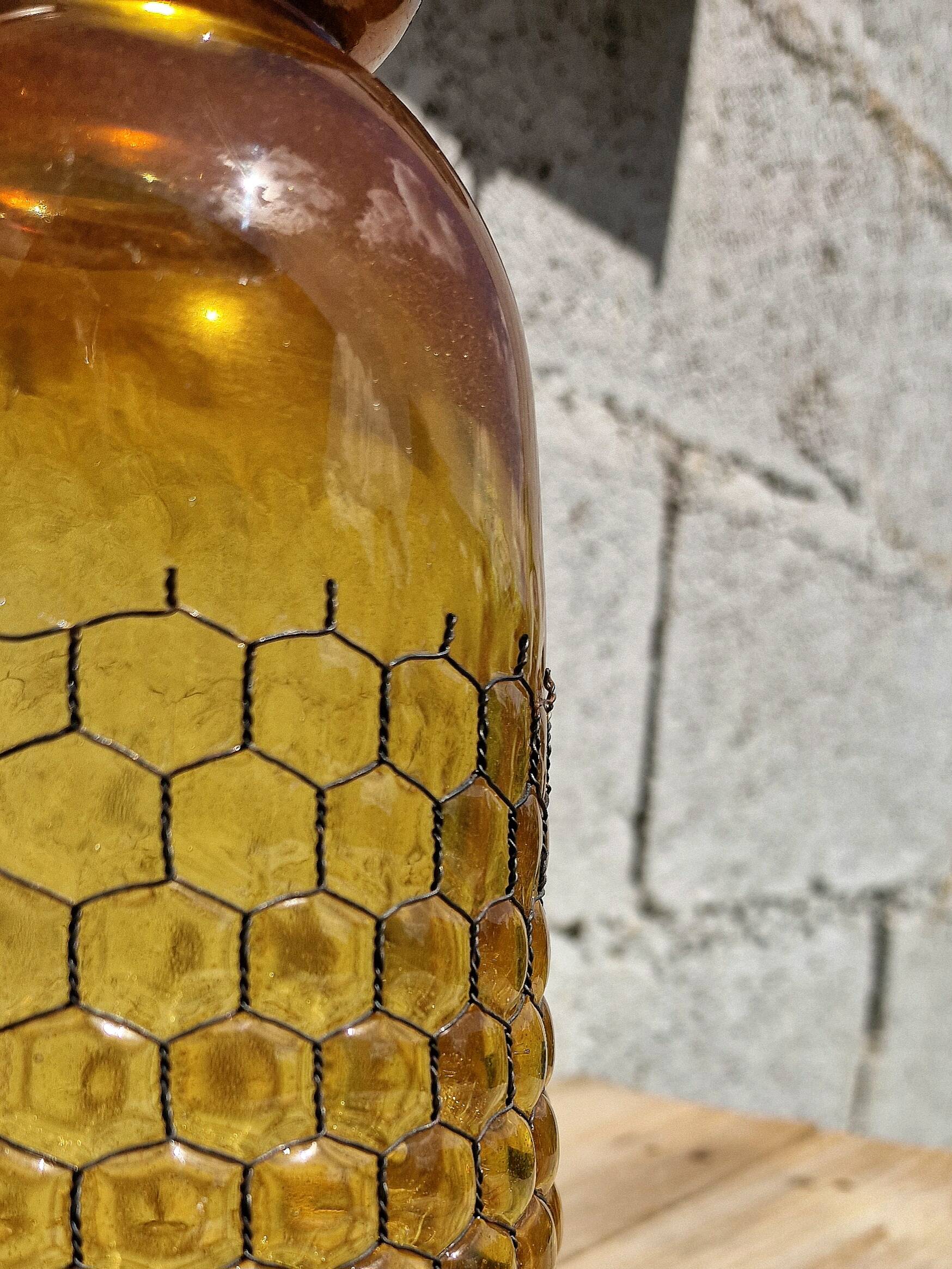 Artisanal blown amber glass vase with integrated honeycomb structure.