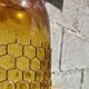 Artisanal blown amber glass vase with integrated honeycomb structure.