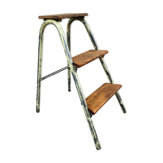 Old wooden and patinated metal ladder