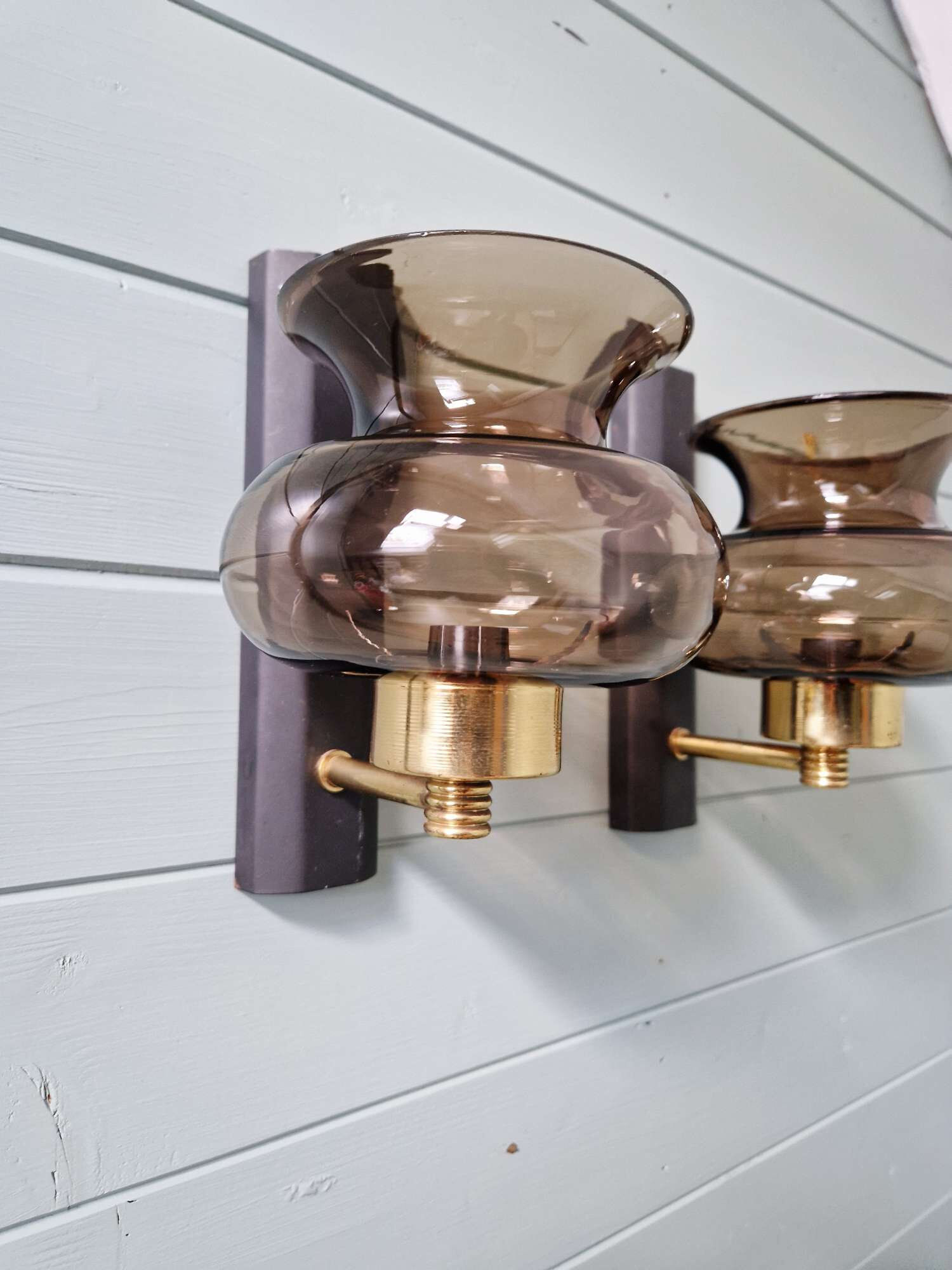 Pair of wall sconces in brass and smoked glass, 1960s.