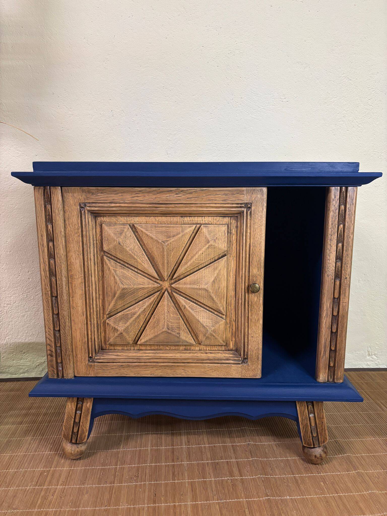 Small vintage upcycled side table in midnight blue and raw wood, with a rose-shaped door.