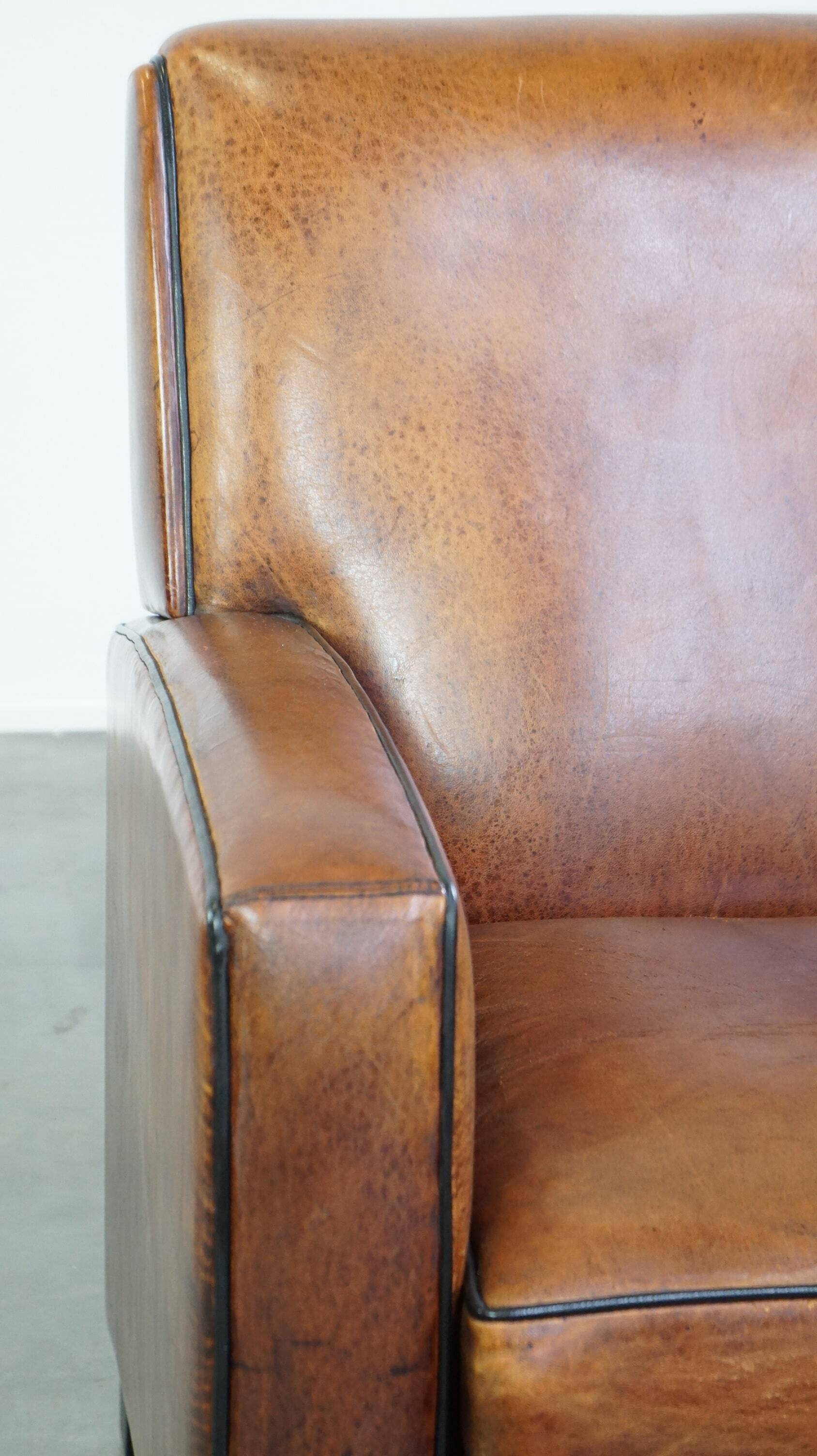 Art Deco design sheepskin leather armchair with a stunning patina