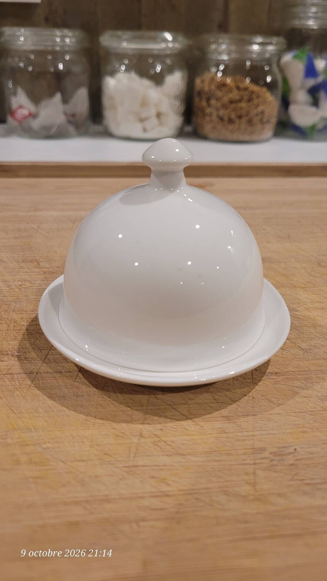 White porcelain butter dish accompanied by its matching bell.