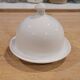 White porcelain butter dish accompanied by its matching bell.