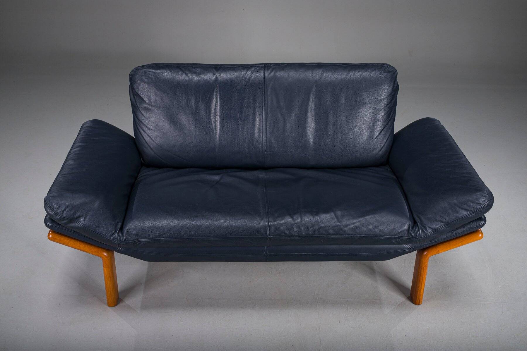 Danish teak and navy blue leather 2-seater sofa from Komfort, 1970s