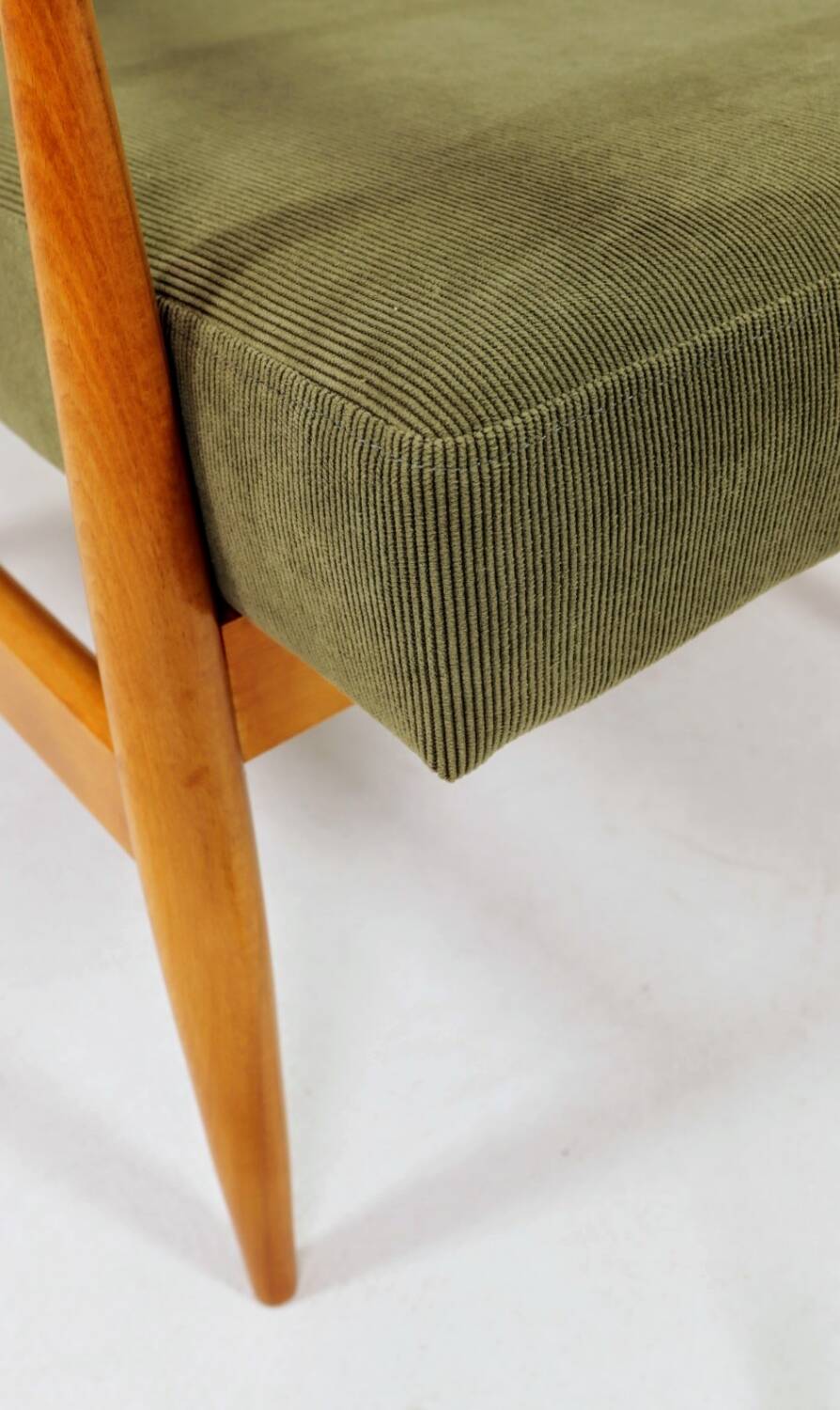 Mid-century modern design armchair in olive green corduroy.