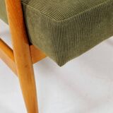 Mid-century modern design armchair in olive green corduroy.