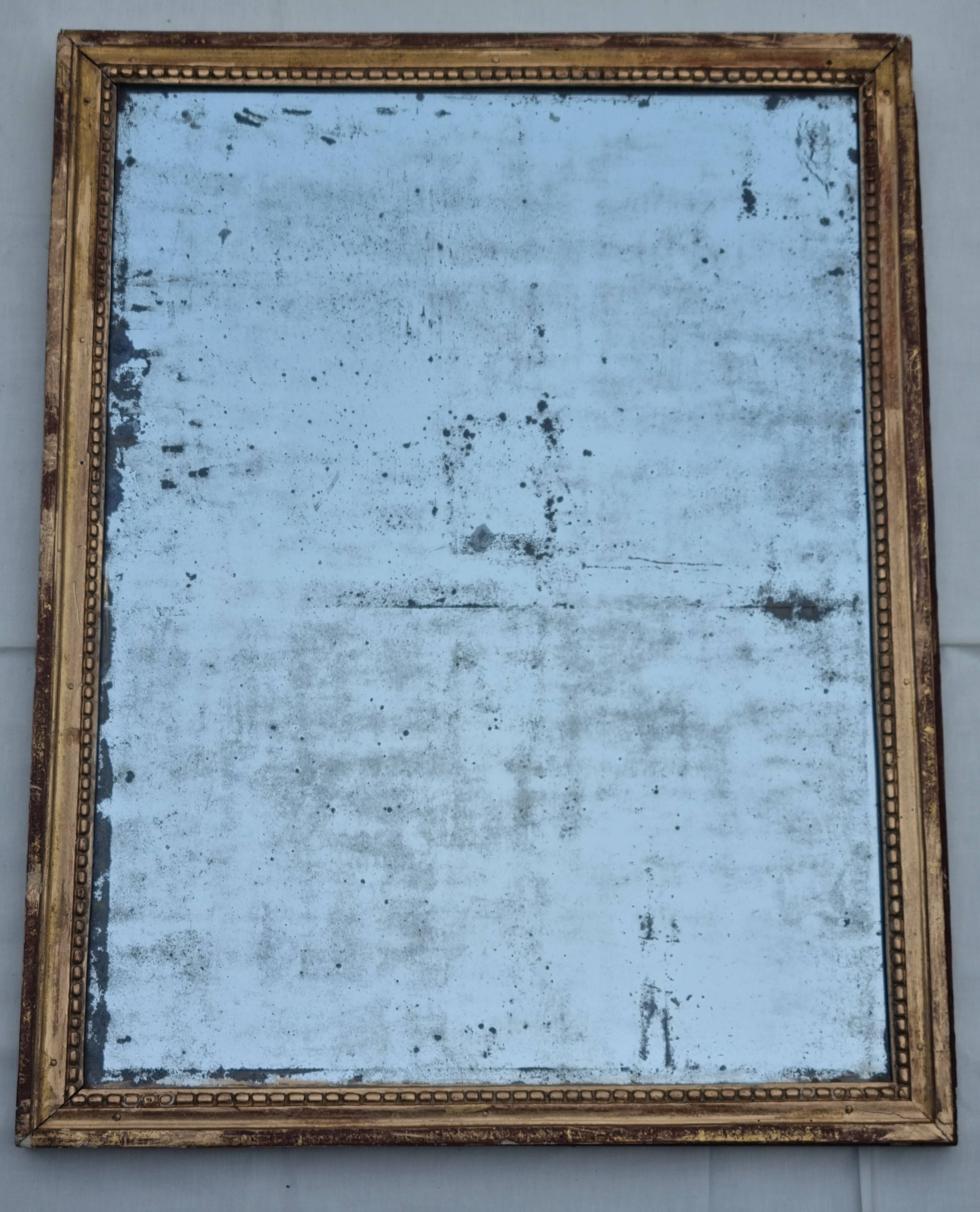 Antique mirror in a gilded wooden frame in the Louis XVI style, 19th century, 62x78 cm.