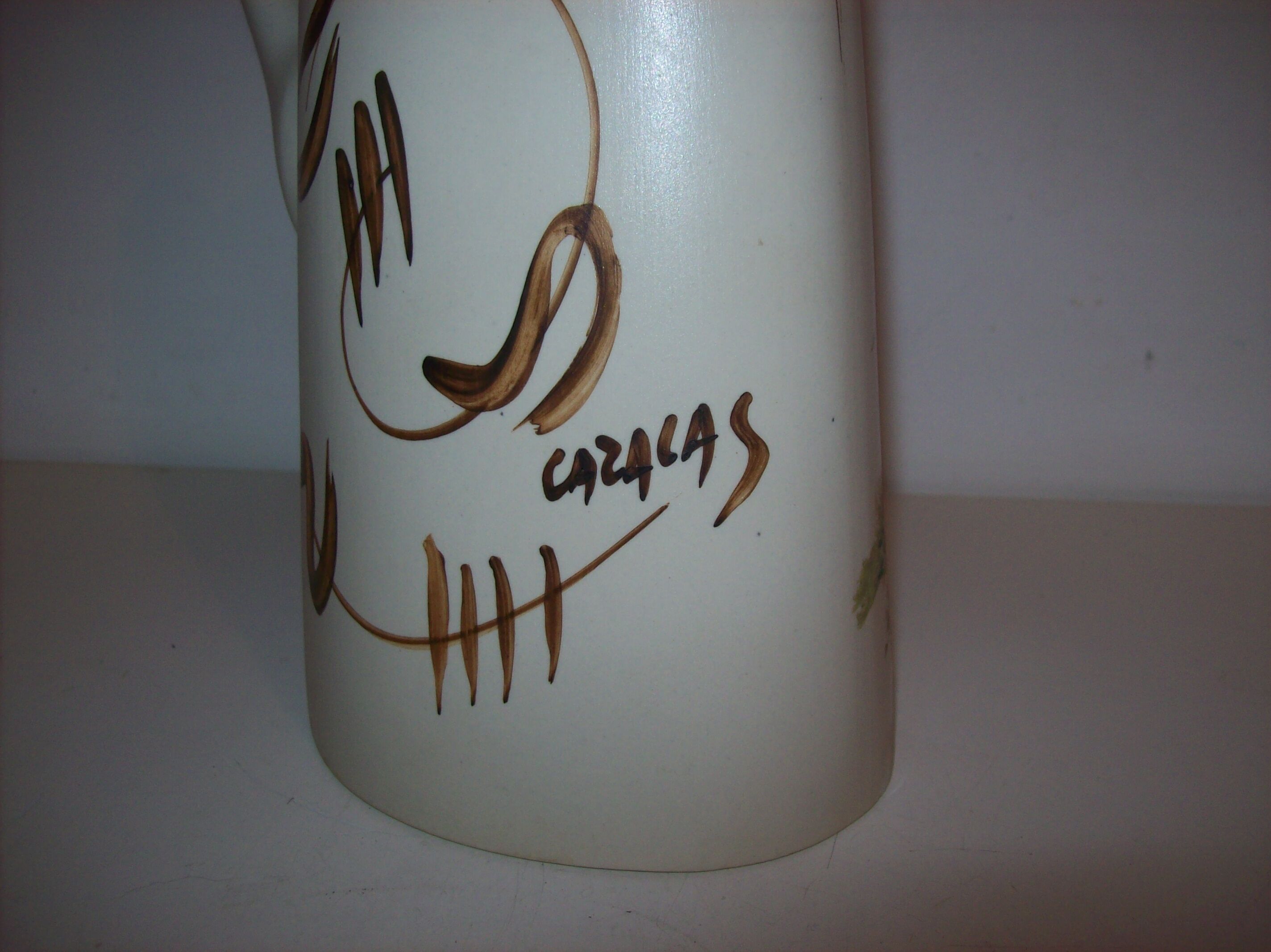 Ceramic pitcher with hand-painted decoration