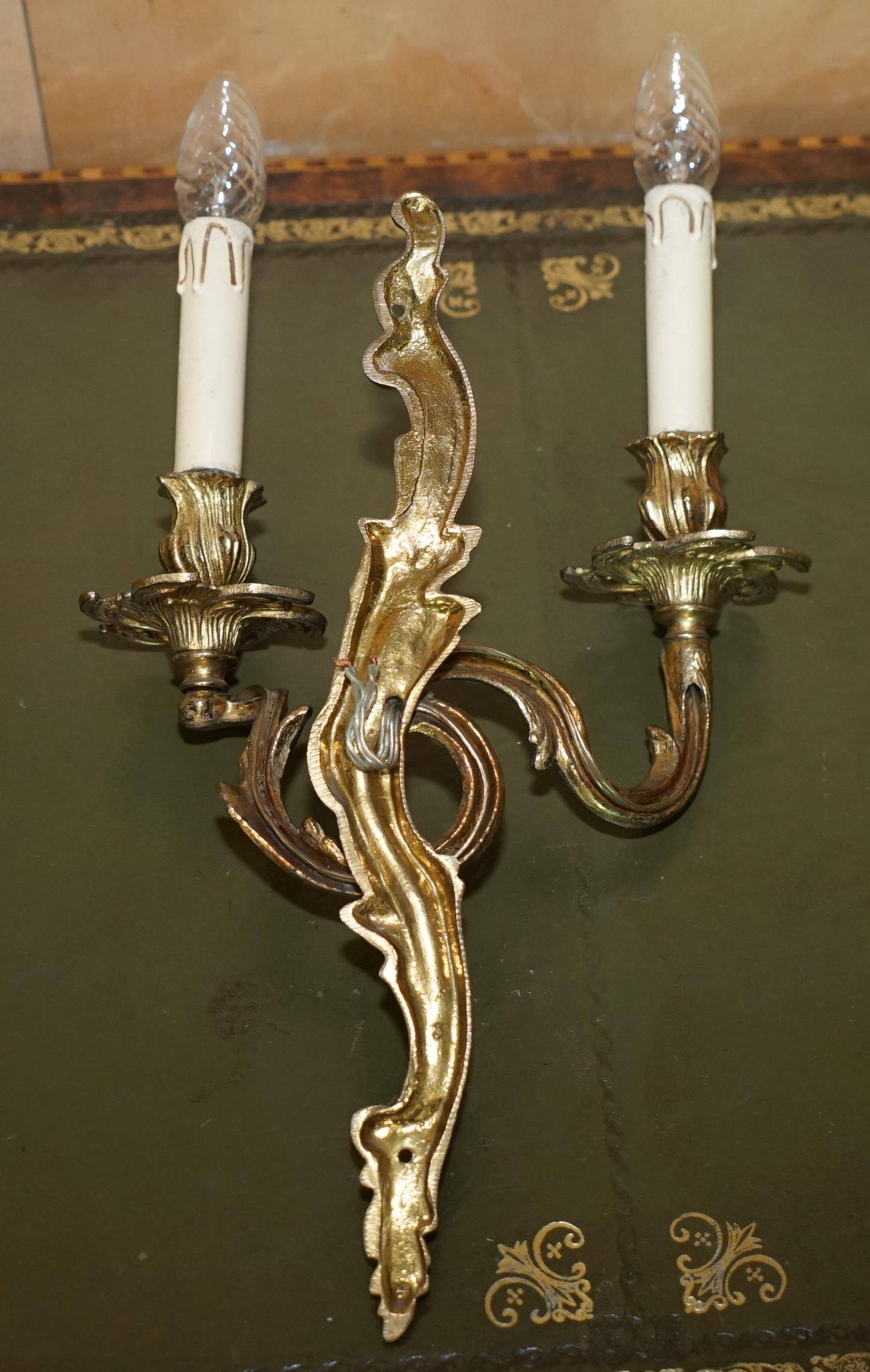 Pair of antique wall sconces from the 1920s in gilded bronze.