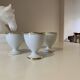Set of 4 vintage egg cups in white porcelain with a gold rim.
