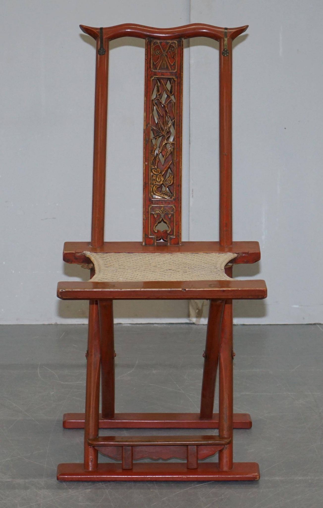 Antique Chinese folding chair with carvings, circa 1900-1920.