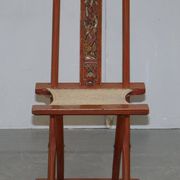 Antique Chinese folding chair with carvings, circa 1900-1920.